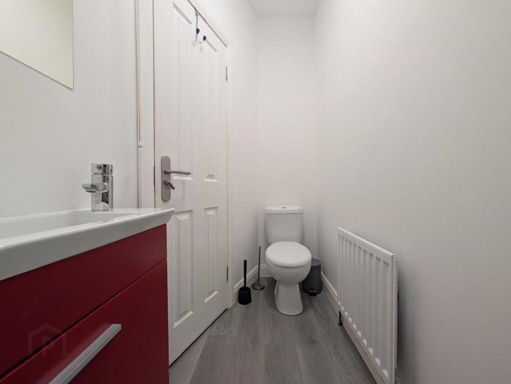 a bathroom with a white toilet and a sink at Private Room in Eglantine Avenue in Central Belfast in Belfast