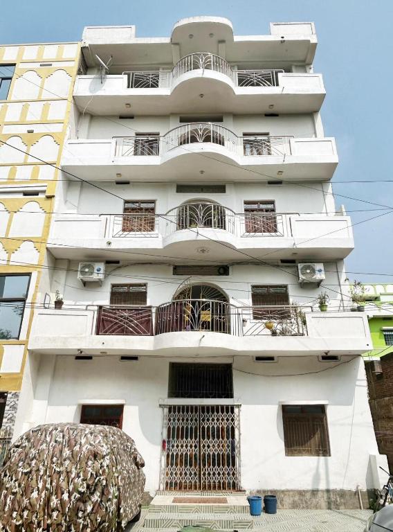 a white building with balconies on it at Shahi House in Bodh Gaya