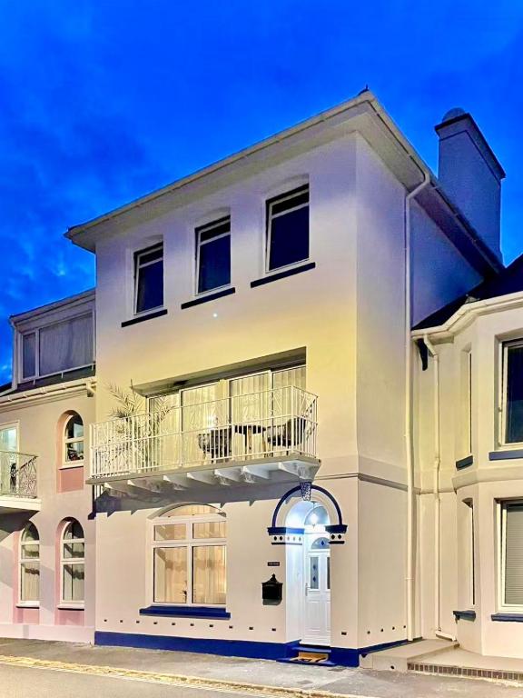 a white house with a balcony on it at York House in Exmouth