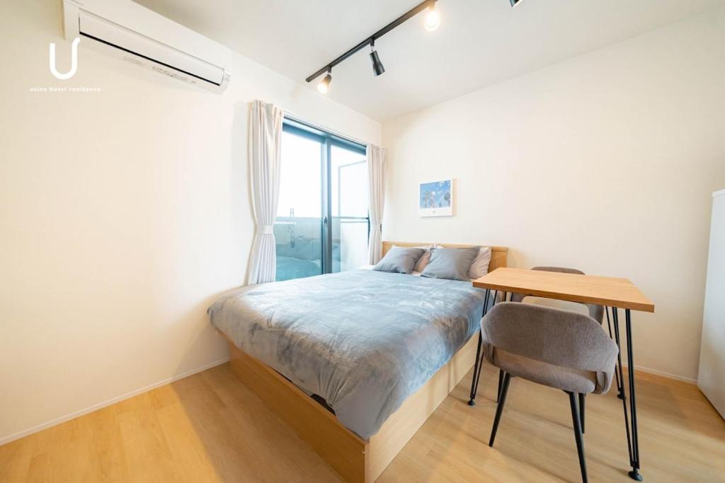 Postel nebo postele na pokoji v ubytování unito residence HAKATA Port 201