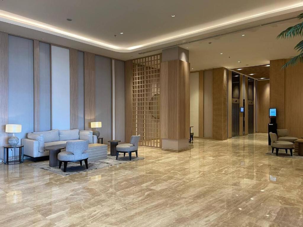 a lobby of a hotel with chairs and tables at Tokyo River side PIK2 By Micky Studio 10 in Muara