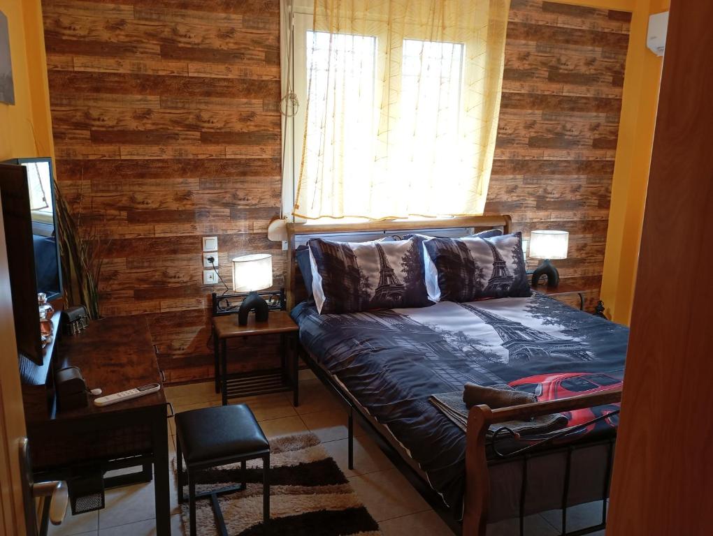 a bedroom with a bed with a wooden wall at DREAM Home Ioannina in Ioannina