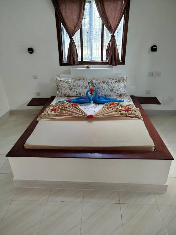 a large bed in a room with a window at Fun Haribo B&B Apartment in Uroa