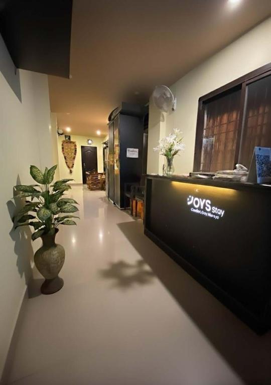 a lobby with a desk and a potted plant at Joys Stay in Trichūr