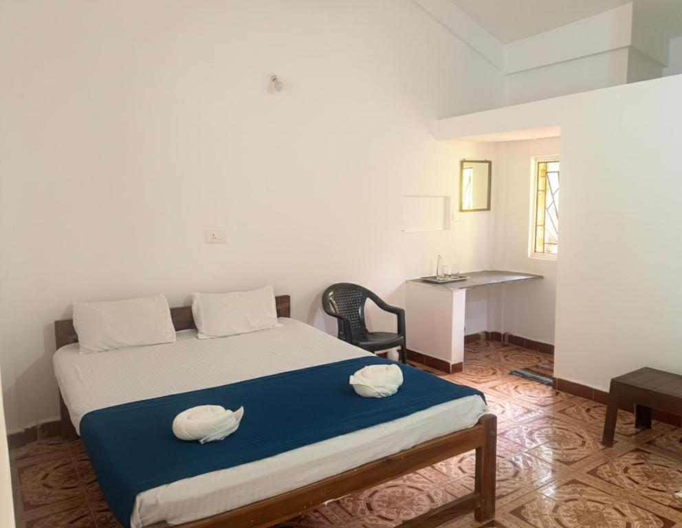 a bedroom with a bed with two pillows on it at Rudresh Guest House in Arambol