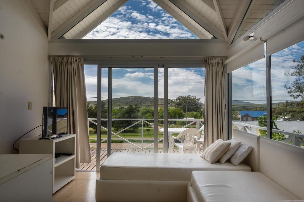 a room with a bed and a large window at Altos de Ventana in Sierra de la Ventana