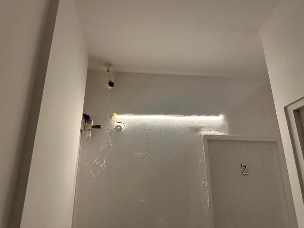 a white room with a door with a number on it at Cozy Haven Downtown Abu Dhabi in Abu Dhabi