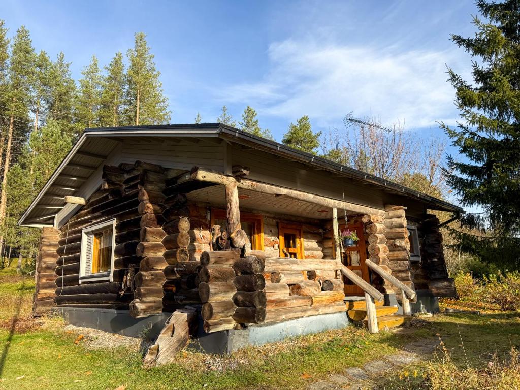 a log cabin in the middle of a forest at Cabin bear's hide in Rovaniemi