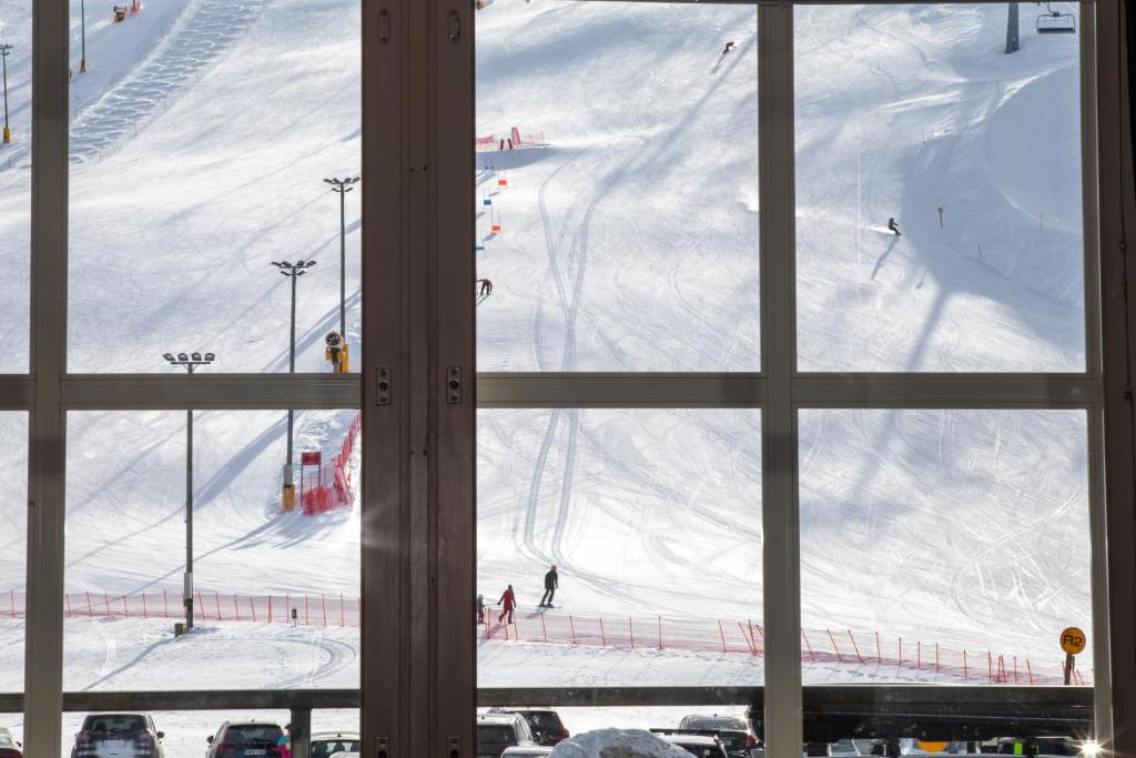 a view of a ski slope from a window at Ski Center Alpine Houses B2 in Kittilä