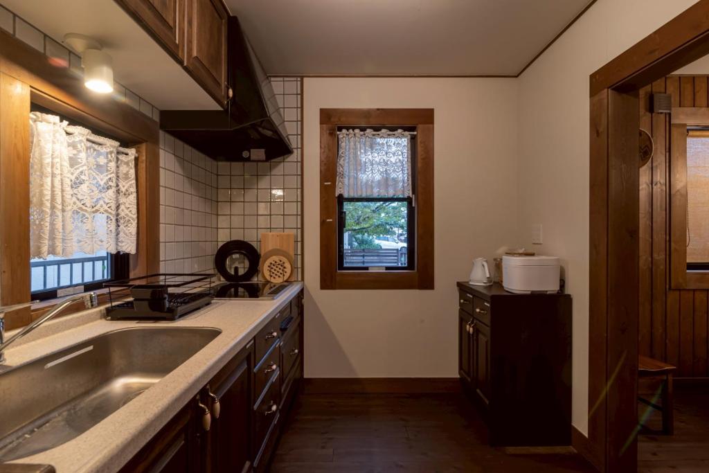 a kitchen with a sink and a counter top at yado suzuka 1 in Suzuka