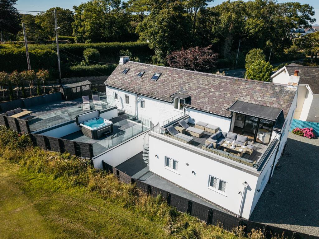 an aerial view of a house with a swimming pool at Stunning Abersoch Cottage by golf course & beach in Abersoch