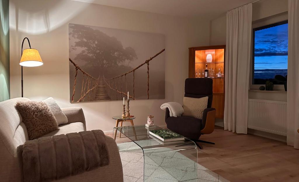 a living room with a couch and two chairs at Ferienwohnung Panorama-Suite in Kappelrodeck