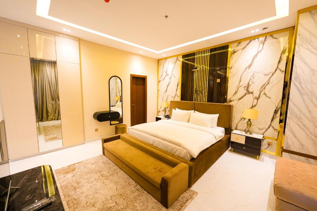 a hotel room with a bed and a mirror at Pavilion Suites - Premium ApartHotel in Bahria Town in Rawalpindi