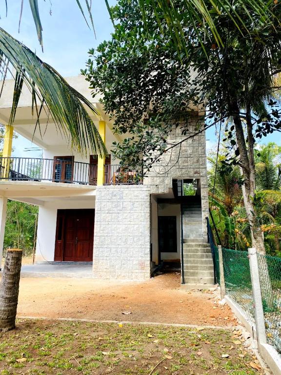 a house with a staircase in front of it at Velora Resort in Anuradhapura