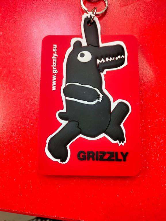 a red christmas tag with a cartoon dog on it at Guest house grizzly in Dzhergalan