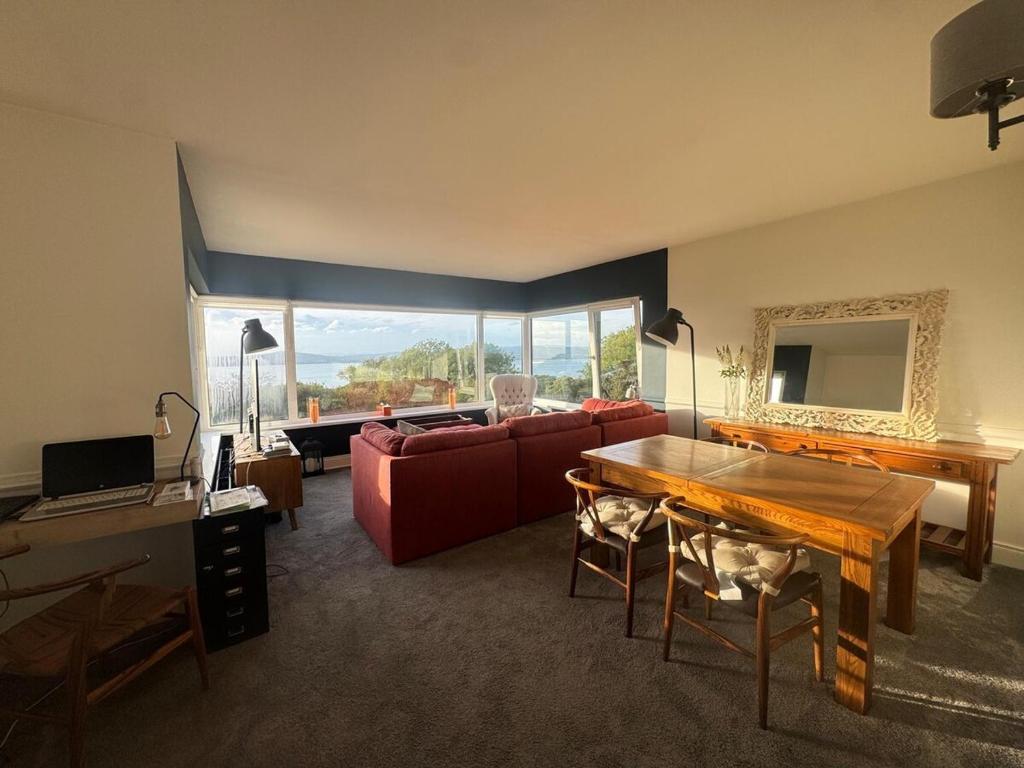 a living room with a red couch and a table at Holywood Hideaway 2 bedroom retreat in Cultra