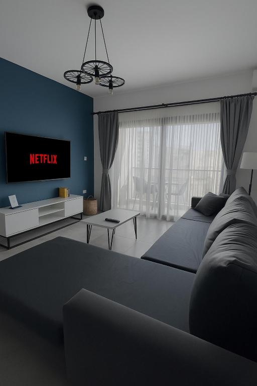 a living room with a bed and a tv at THE PALMiA I iskele I Trikomo in Aglantzia