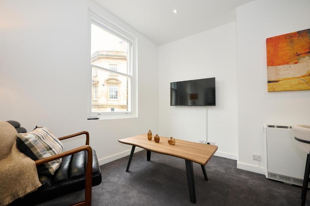 a living room with a couch and a coffee table at 1B Lime Street in Bedford