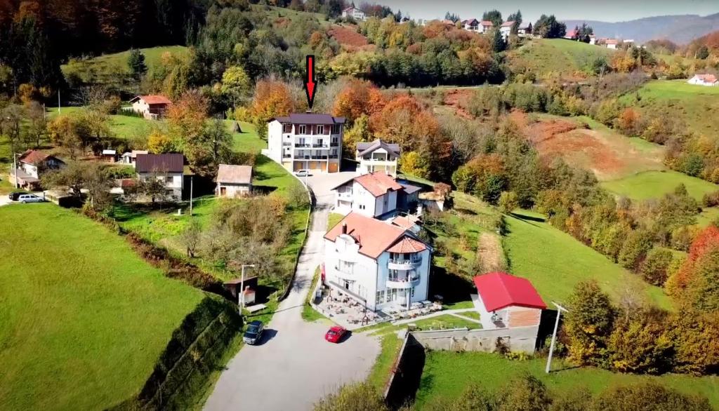 an aerial view of a large house on a river at Apartmani TOKI in Mrkonjić Grad