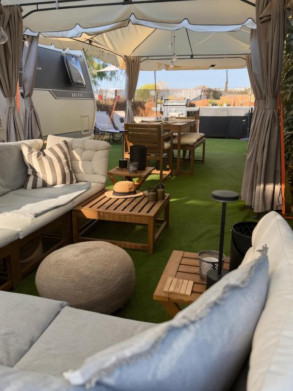 a living room with couches and tables and an umbrella at The Retreat - Armacao de Pera, Algarve Portugal in Pêra