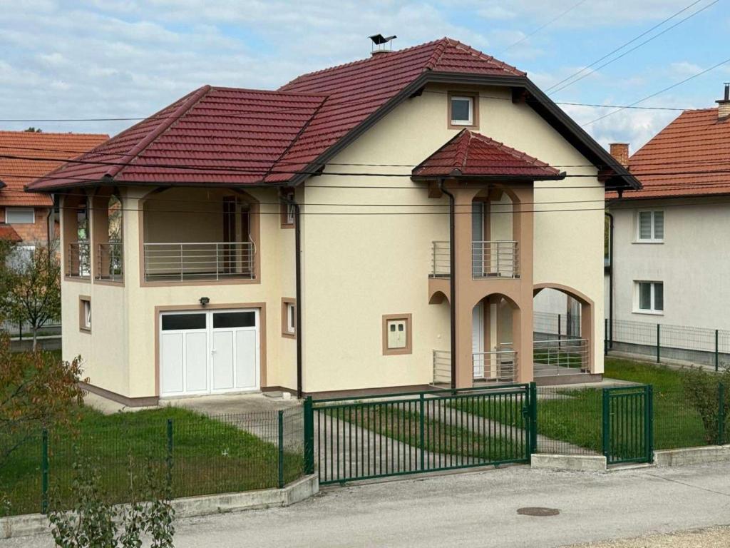 a house with a red roof and a gate at Villa Big Mama in Živinice