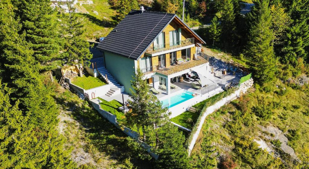 an aerial view of a house with a swimming pool at Villa Stella Verde - Wellness Villa with a swimming pool, hot tub and sauna in Ravna Gora