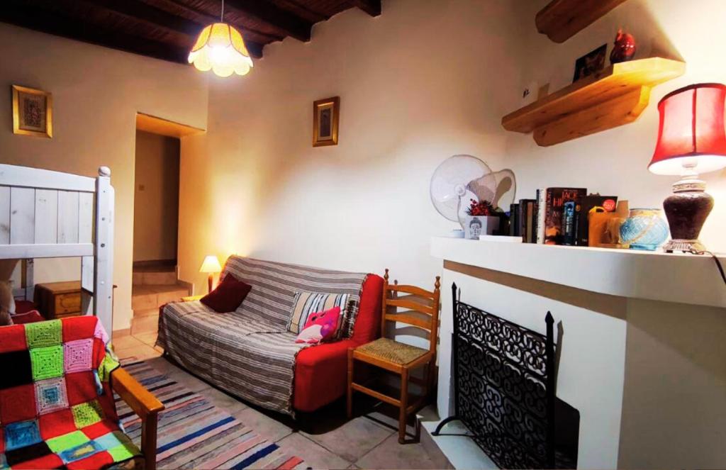 a living room with a couch and a chair at AsteriA 3D House Inn in Pano Arodes