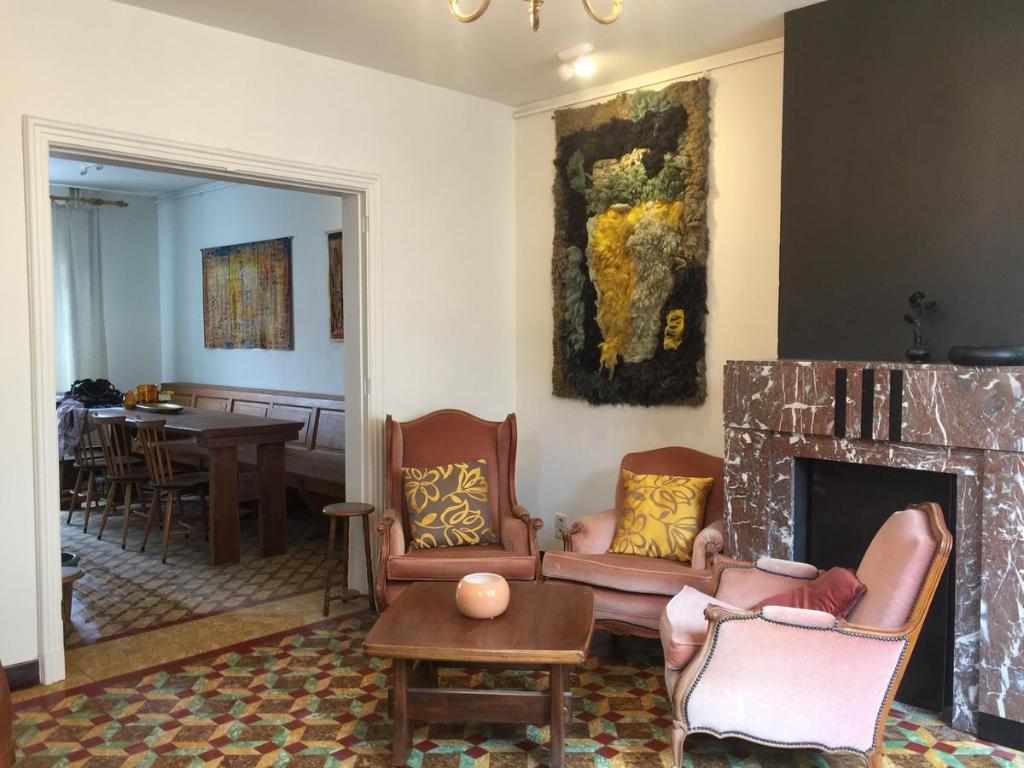 a living room with a couch and a fireplace at Holiday Home near town in Aarschot