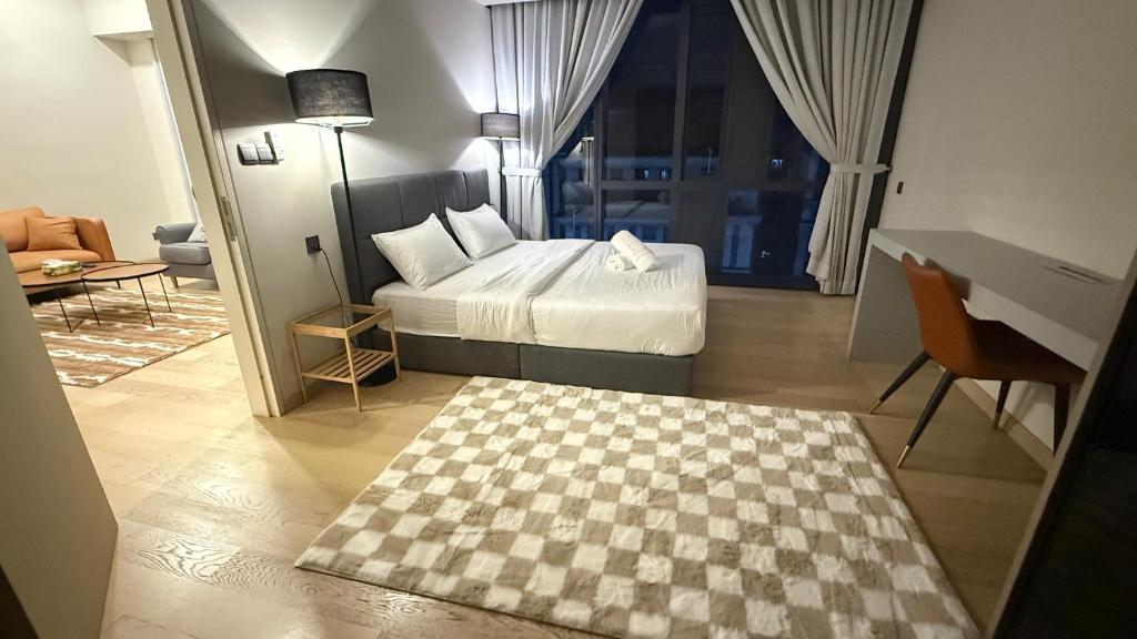 a bedroom with a bed and a checkered floor at KLCC Star Residences by Nexus 11 in Kuala Lumpur