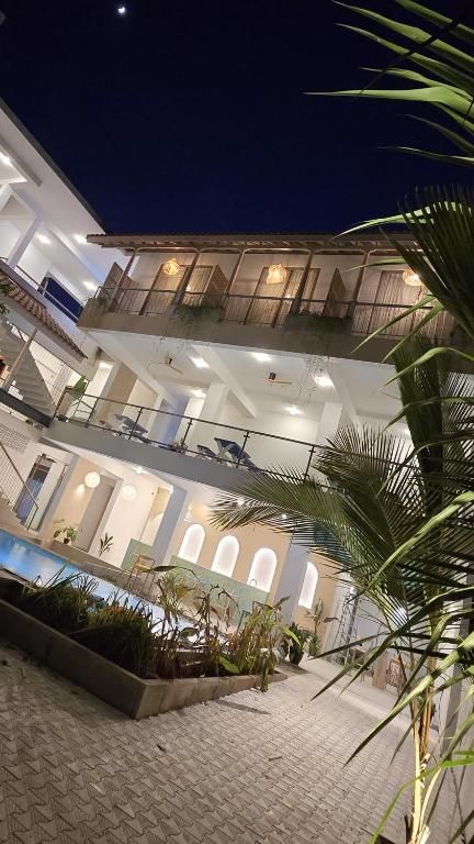 a large building with a lot of plants in it at Brizo Paradiso in Matara