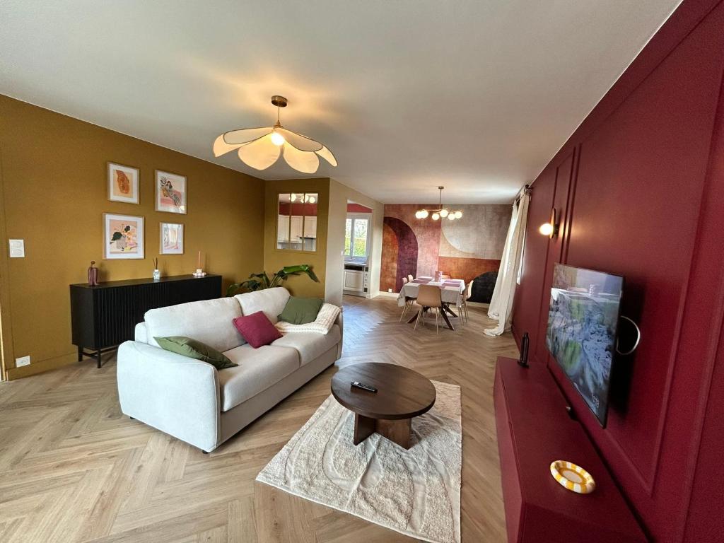 a living room with a white couch and a table at Maison B - Mont Saint Michel in Marcey-les-Grèves