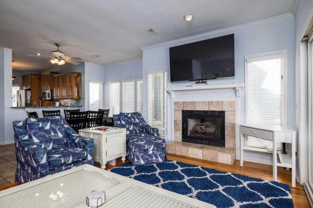 een woonkamer met een bank en een open haard bij 325 Ocean Point in Fripp Island