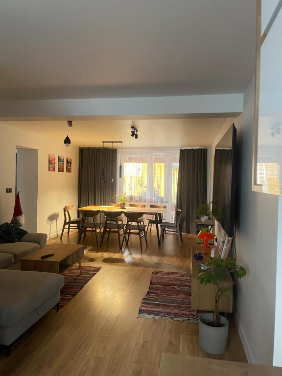 a living room with a table and a dining room at Dom pod orzechem in Spytkowice