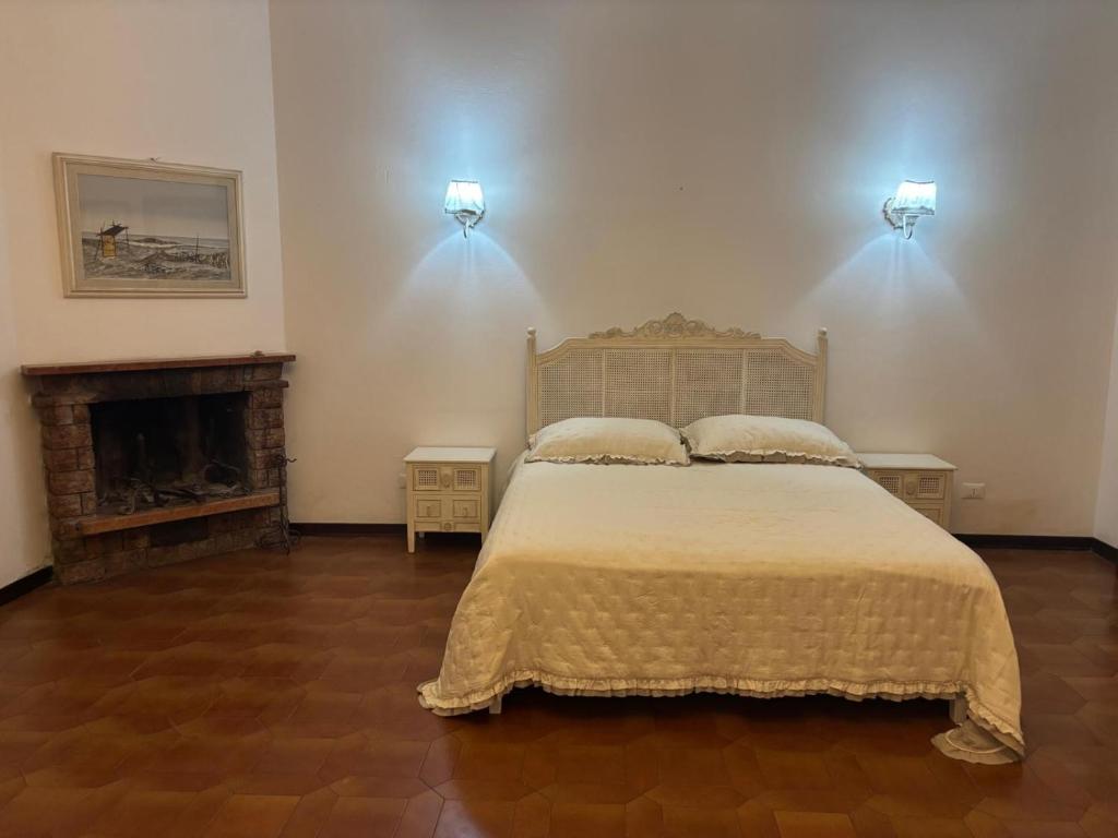a bedroom with a large bed and a fireplace at Minerva in Viareggio