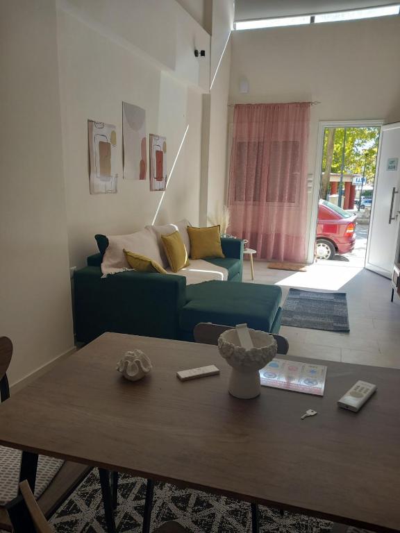 a living room with a blue couch and a table at loft ΑLEXIA in Pyrgos