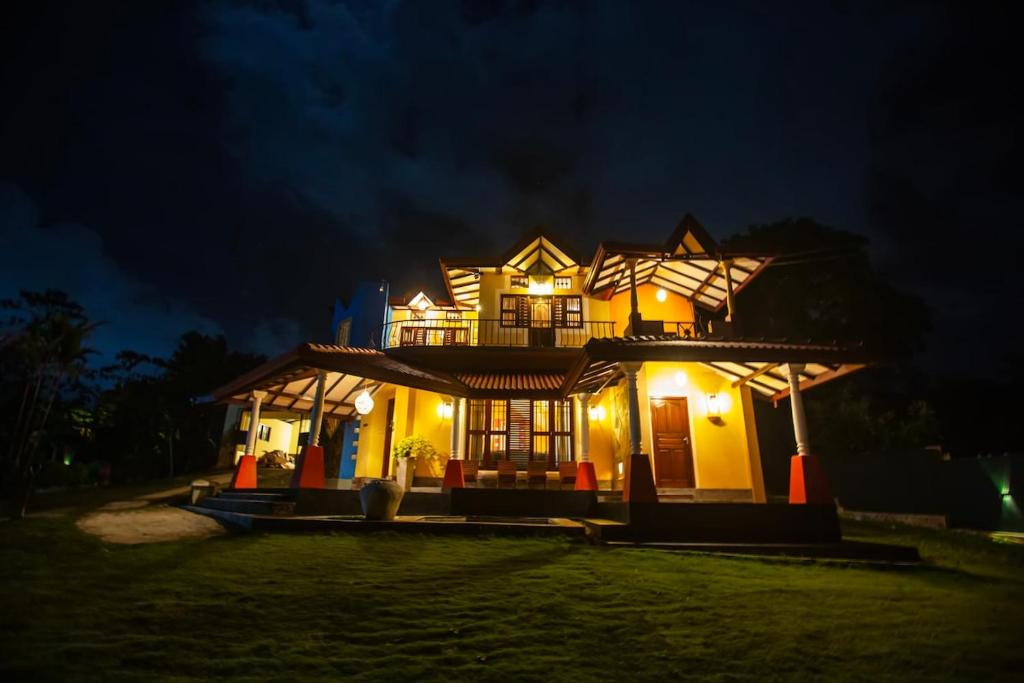 a house lit up at night with lights at Mountvilla Exquisite 4-Bedroom Luxury Retreat with Private Pool in Galle