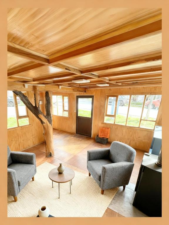 a living room with two chairs and a table at Futa House in Futaleufú
