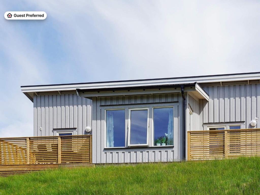 a house with a wooden fence in front of it at 5 person holiday home in STRÖMSTAD in Strömstad