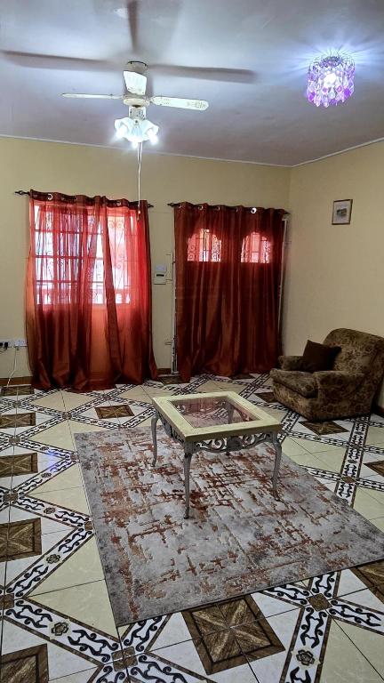een woonkamer met een bank en een tafel bij NR Investments in Kingstown