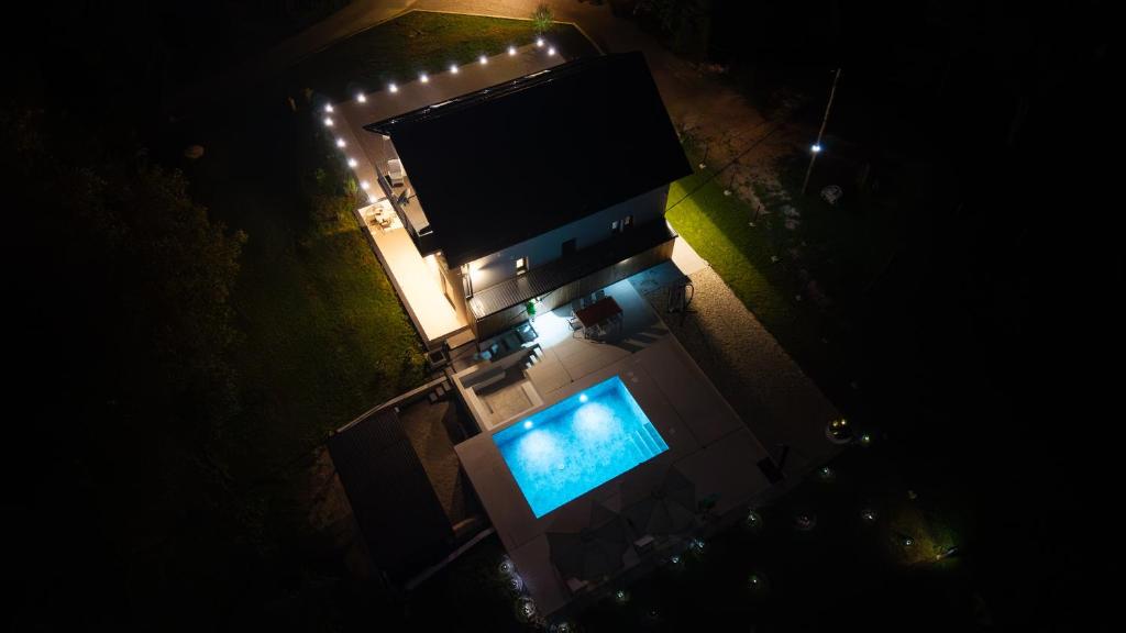 an overhead view of a swimming pool at night at Villa Peregrine Plitvice Lakes 