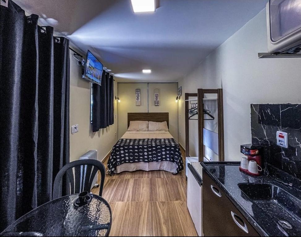 a small room with a bed in the middle of it at Villa de Recriary in Campos do Jordão