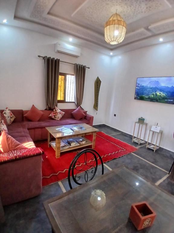 a living room with a couch and a table at فيلا رياض عمران in Douar Blidene