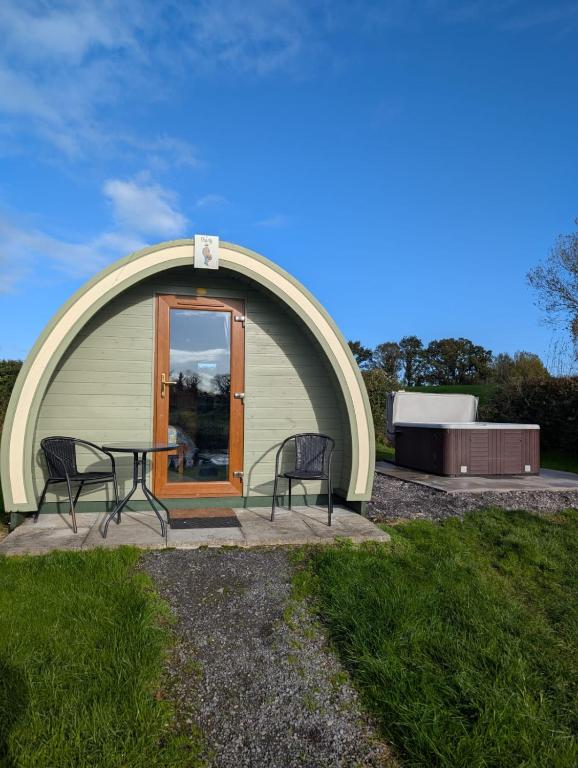 a circular building with a table and chairs in front of it at Glamping Pod Thady Killynick County Fermanagh in Killyhevlin