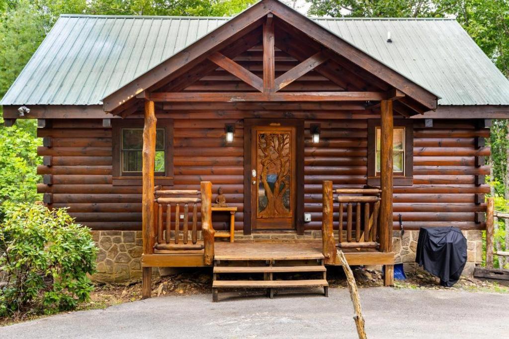 a log cabin with a porch and a door at Sereni-Tree Cabin in the Smokey Mountains in Sevierville