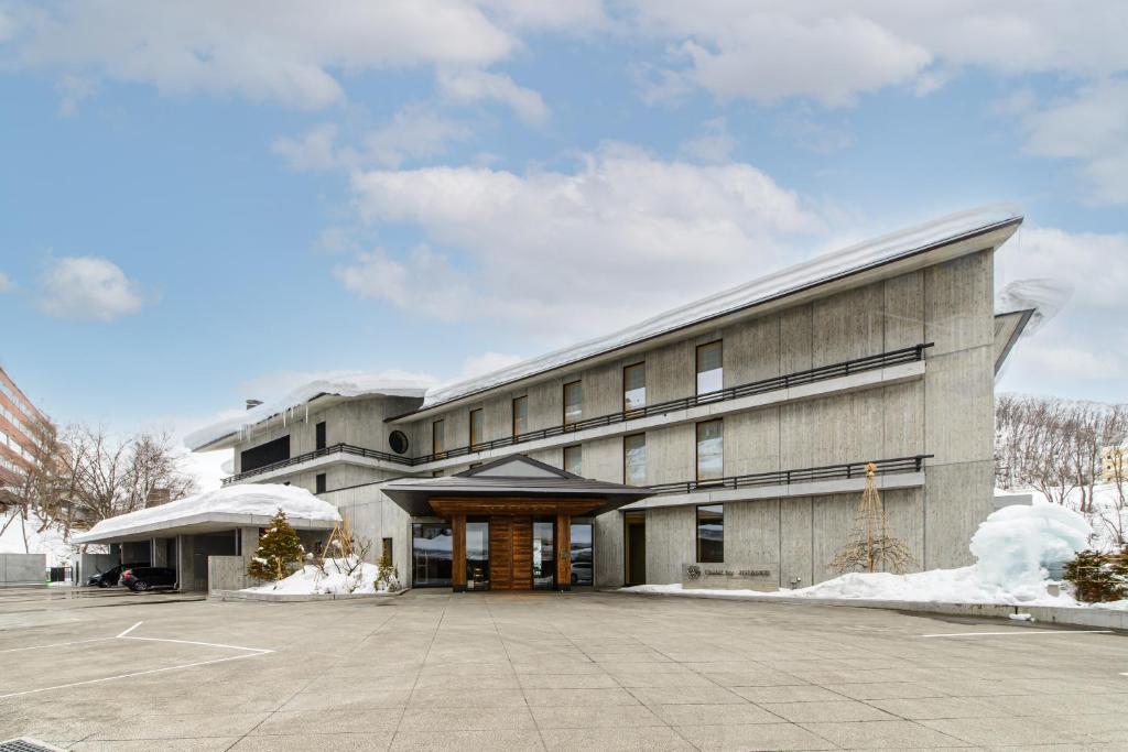 a large building with a parking lot in front of it at Chalet Ivy Jozankei in Jozankei