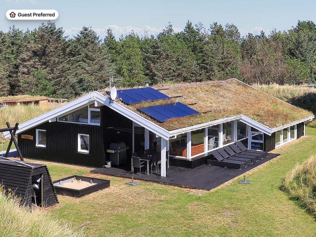 a house with a roof with solar panels on it at 14 person holiday home in Blokhus-By Traum in Blokhus