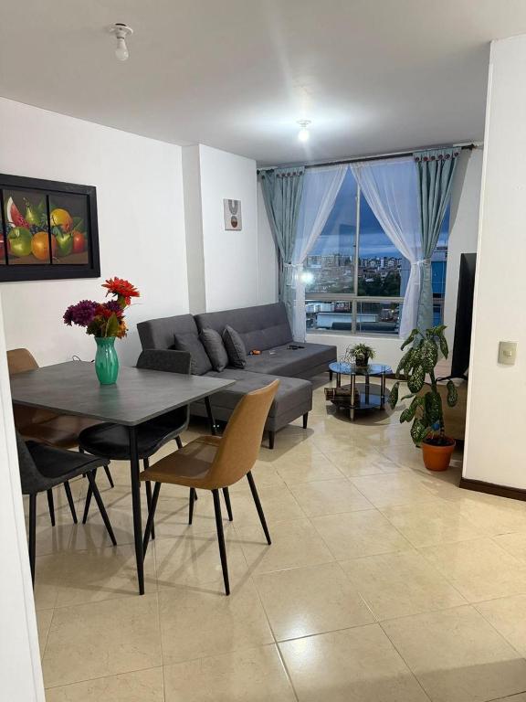 a living room with a table and a couch at Torrecoral704 in Estación El Salto