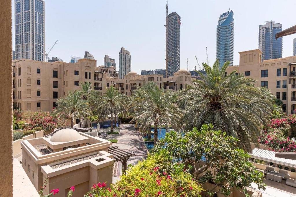 a view of a city with palm trees and buildings at Downtown Zaafaran 2, in Dubai