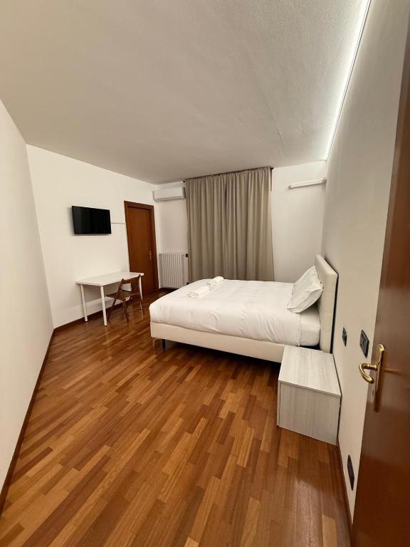 a hotel room with a bed and a table at Acqueria Residence in Vigonza