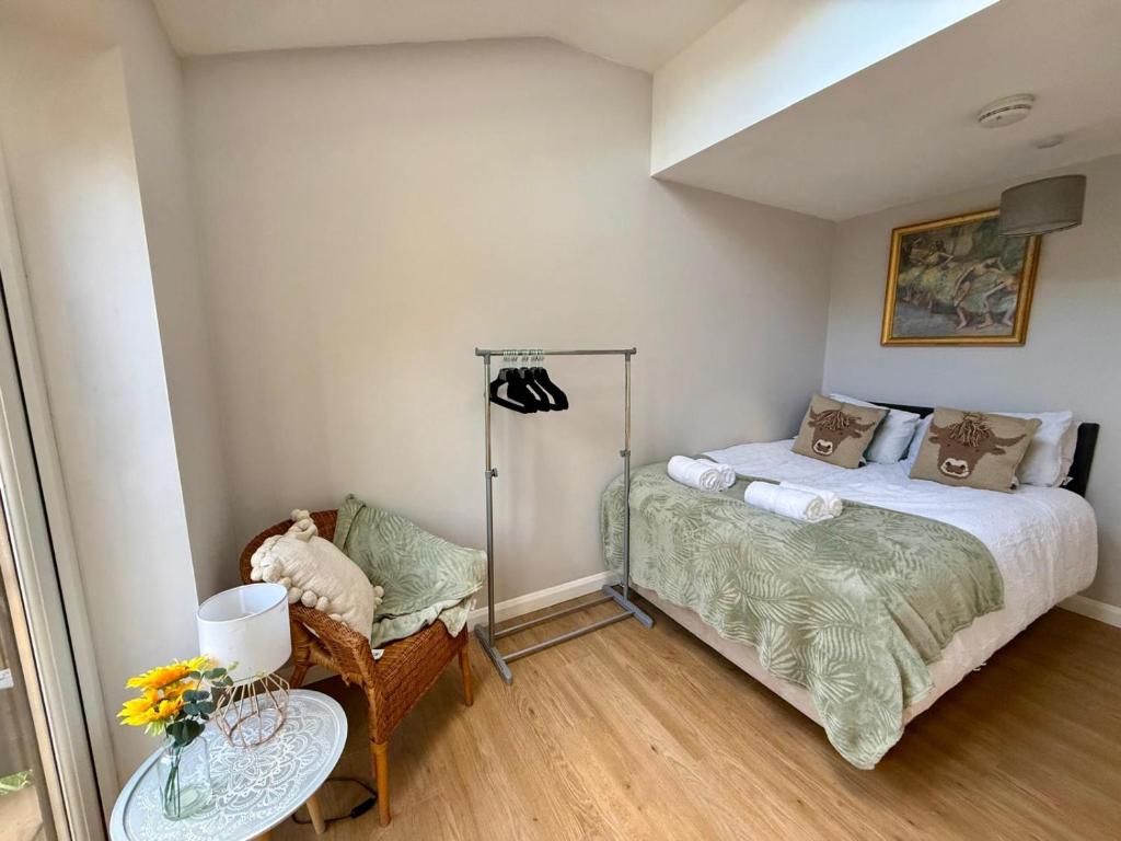 a small bedroom with a bed and a chair at Squires House Long Stays Sleep 10 Free Parking 